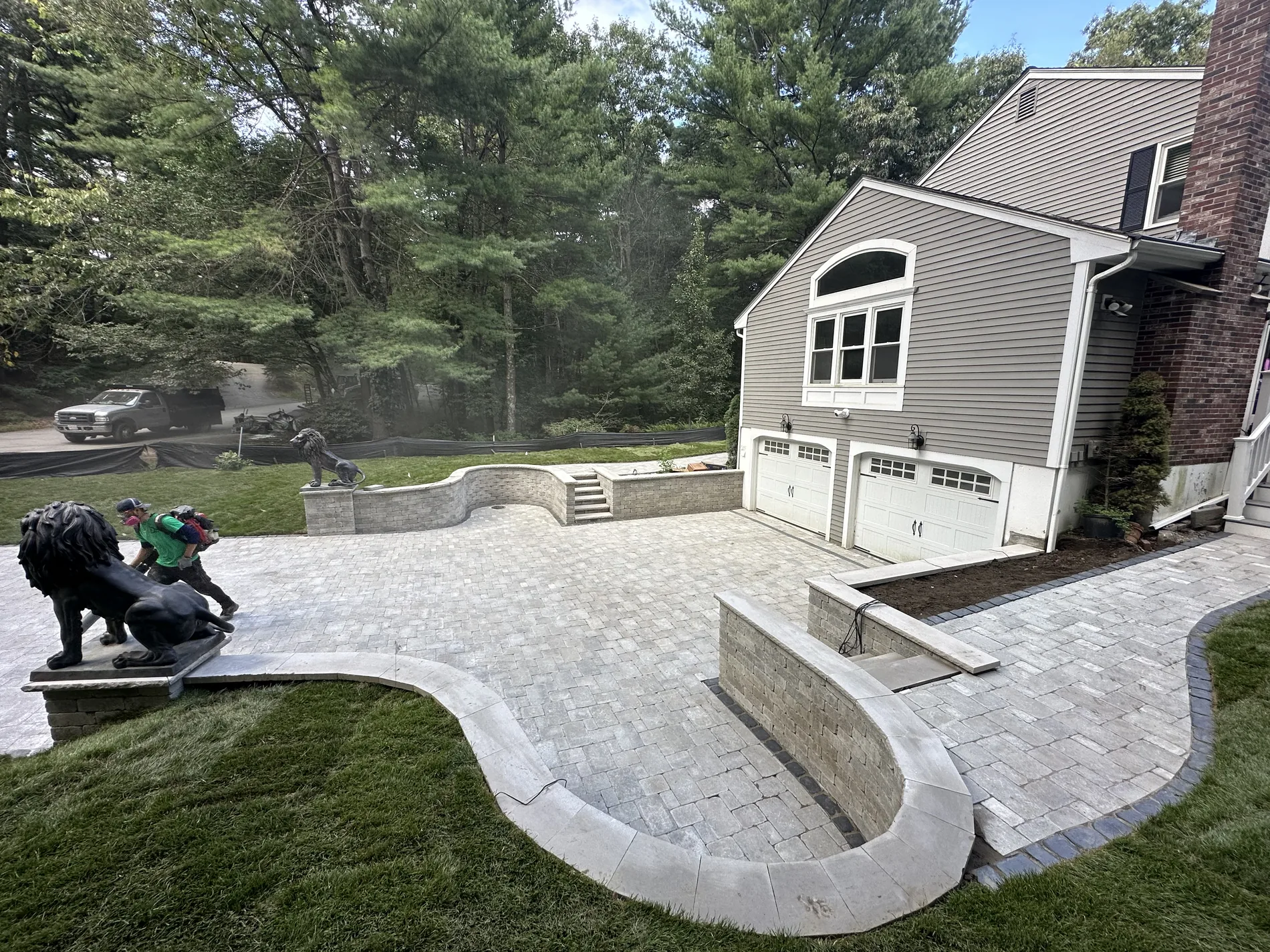 Completed Roots 'n Shoots stone patio and curved masonry landscape